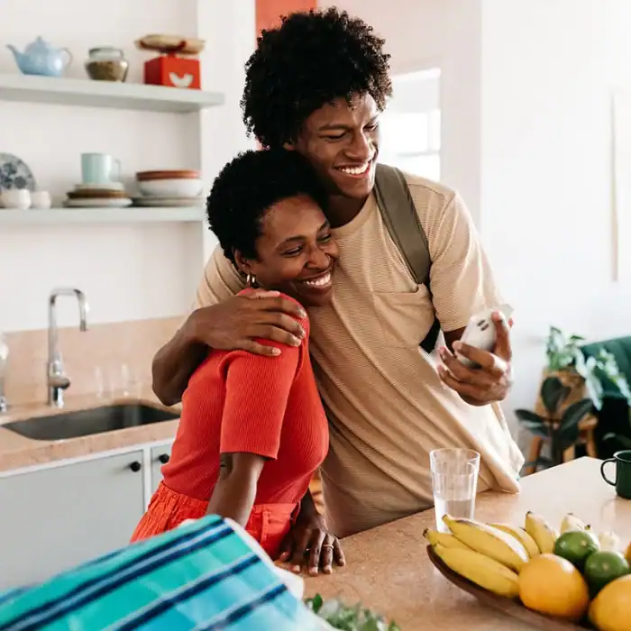 Mother and son taking a selfie in a kitchen setting
